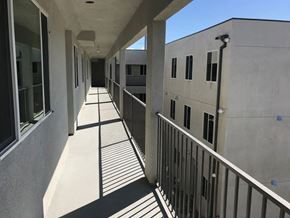 Panorama City apartment for rent - a corridor in an office building with shadows on the ground