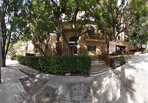 Los Angeles apartment for rent - a building with stairs and trees in front of it