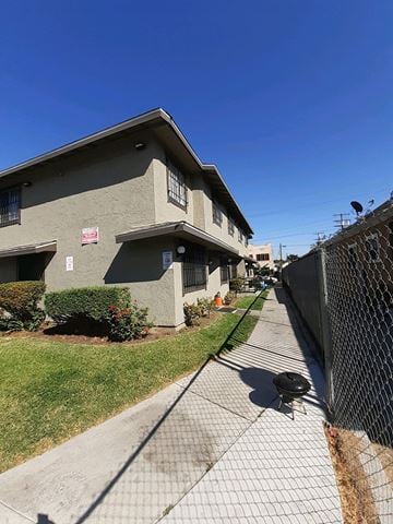 Los Angeles apartment for rent - A grey building with a fence in front of it.
