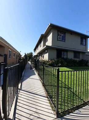 Los Angeles apartment for rent - A black metal fence runs along a sidewalk.