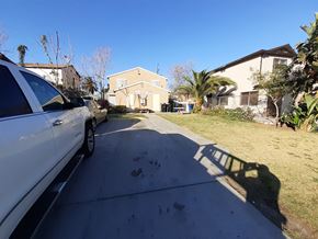 Los Angeles apartment for rent - A white car is parked on a driveway in front of a house.