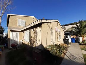 Los Angeles apartment for rent - A house with a red chair and a blue trash can in front of it.
