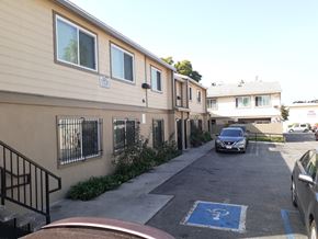 Los Angeles apartment for rent - A parking lot with a car parked in a handicap spot.