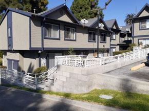 Los Angeles apartment for rent - A row of houses with a white fence in front.