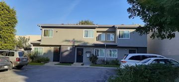 North Hollywood apartment for rent - A two-story building with a parking lot in front.