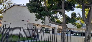 North Hollywood apartment for rent - A white building with a black fence in front of it.