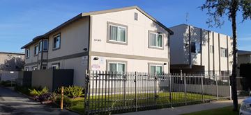Van Nuys apartment for rent - A white house with a black fence in front of it.