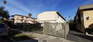 Van Nuys apartment for rent - A house with a fence in front of it.