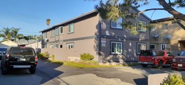 North Hollywood apartment for rent - A two-story building with a parking lot in front.