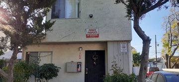 North Hollywood apartment for rent - A white building with a red and white sign on the front.
