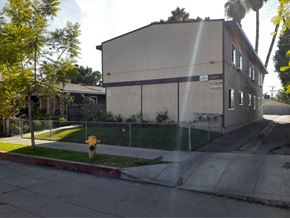 North Hollywood apartment for rent - A building with a fence and a yellow fire hydrant in front of it.