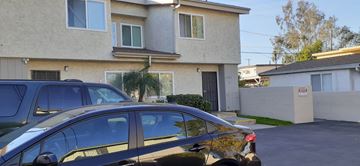 North Hollywood apartment for rent - A black car is parked in front of a two-story house.