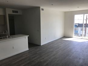 Panorama City apartment for rent - A large empty room with a kitchen area to the left.