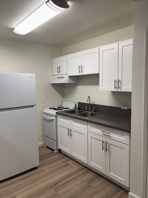 Reseda apartment for rent - A kitchen with white appliances and cabinets.
