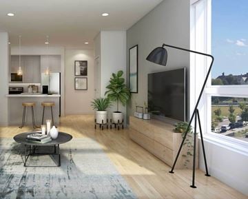 Providence apartment for rent - A modern living room with a black floor lamp and a flat screen TV.