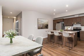 Portage La Prairie apartment for rent - a kitchen and dining room with a marble table and chairs