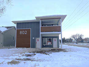 Brandon apartment for rent - the front of a building with snow on the ground