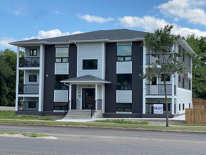 Brandon apartment for rent - a white and black apartment building on the corner of a street