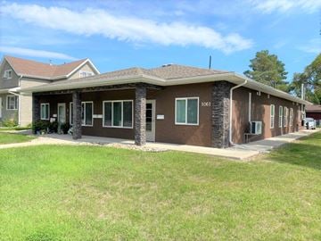 Brandon apartment for rent - a brown house with a lawn in front of it