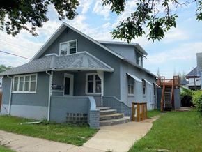 Brandon apartment for rent - a blue house with stairs and a sidewalk