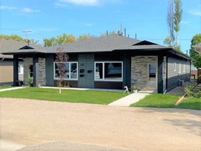 Brandon apartment for rent - the front of a house with a driveway and lawn