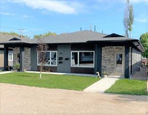 Brandon apartment for rent - a gray and green house with a lawn and a sidewalk
