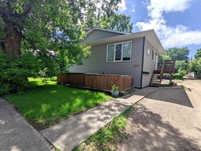 Brandon apartment for rent - a home with a wooden fence and a sidewalk in front of it