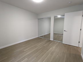 Brandon apartment for rent - a bedroom with wood flooring and white walls and doors