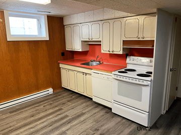 Brandon apartment for rent - an empty kitchen with white appliances and red counter tops