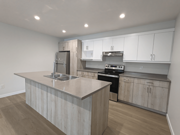Brandon apartment for rent - a kitchen with white cabinets and a marble counter top