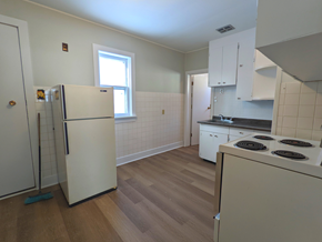 Brandon apartment for rent - an empty kitchen with white appliances and a window