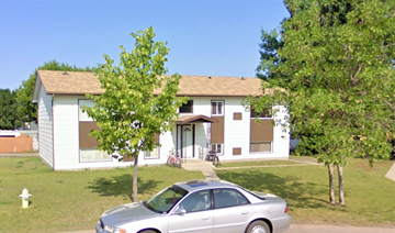 Brandon apartment for rent - a white house with a car parked in front of it