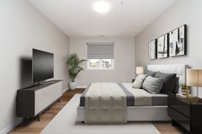 Portage La Prairie apartment for rent - a bedroom with a large bed and a tv