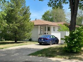 Brandon apartment for rent - a blue car parked in front of a house