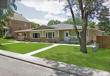 Brandon apartment for rent - a house with a yard and a tree in front of it