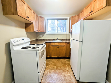 Brandon apartment for rent - an empty kitchen with a stove refrigerator and sink