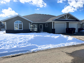 Brandon condo for rent - a snow covered yard in front of a house