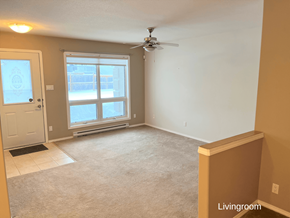 Brandon apartment for rent - an empty living room with a ceiling fan and a window