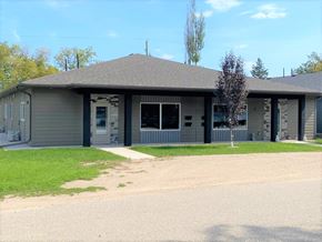 Brandon apartment for rent - a gray building with a tree in front of it