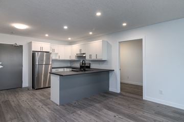 Brandon apartment for rent - a kitchen with white cabinets and a stainless steel refrigerator