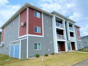 Brandon apartment for rent - the exterior of an apartment building with gray and red siding