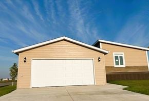 Brandon apartment for rent - A house with a white garage door and a brown siding.
