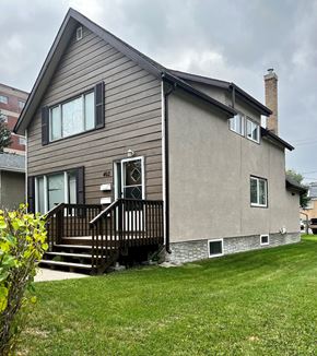 Brandon triplex for rent - the back of a house with a backdoor and a deck