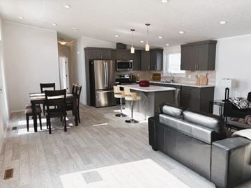 Brandon apartment for rent - A modern kitchen with a dining table and a couch.