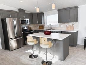 Brandon apartment for rent - A modern kitchen with a large island and bar stools.