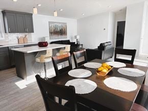 Brandon apartment for rent - A modern dining room with a wooden table set for six.