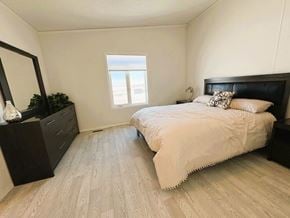 Brandon apartment for rent - A bedroom with a bed, nightstand, and a mirror.
