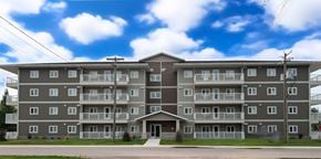 Killarney apartment for rent - A large apartment building with a grey facade and balconies.