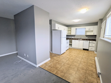 Brandon apartment for rent - an empty kitchen with white appliances and a tiled floor