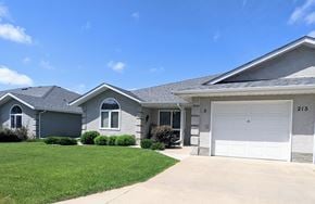 Brandon apartment for rent - a gray house with a white garage door and a lawn